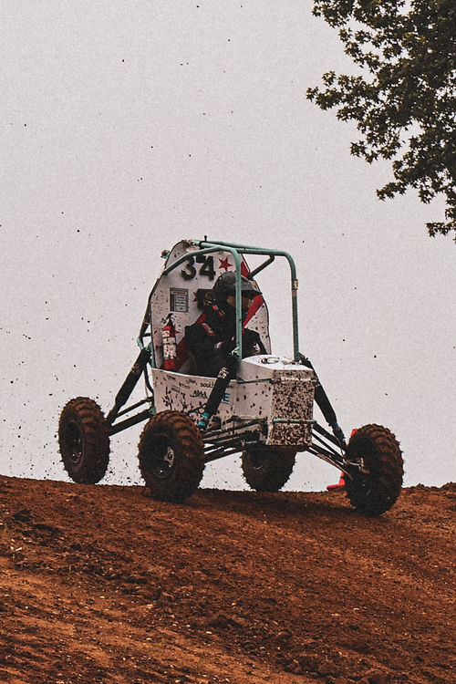GW Baja car cresting a dirt hill mid-jump