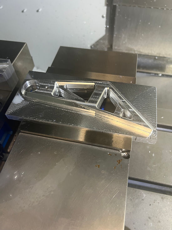 Finished machined brake pedal lever on the mill bed