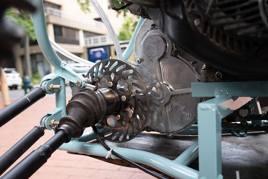 Gearbox installed on the vehicle with brake rotor and CV boot visible